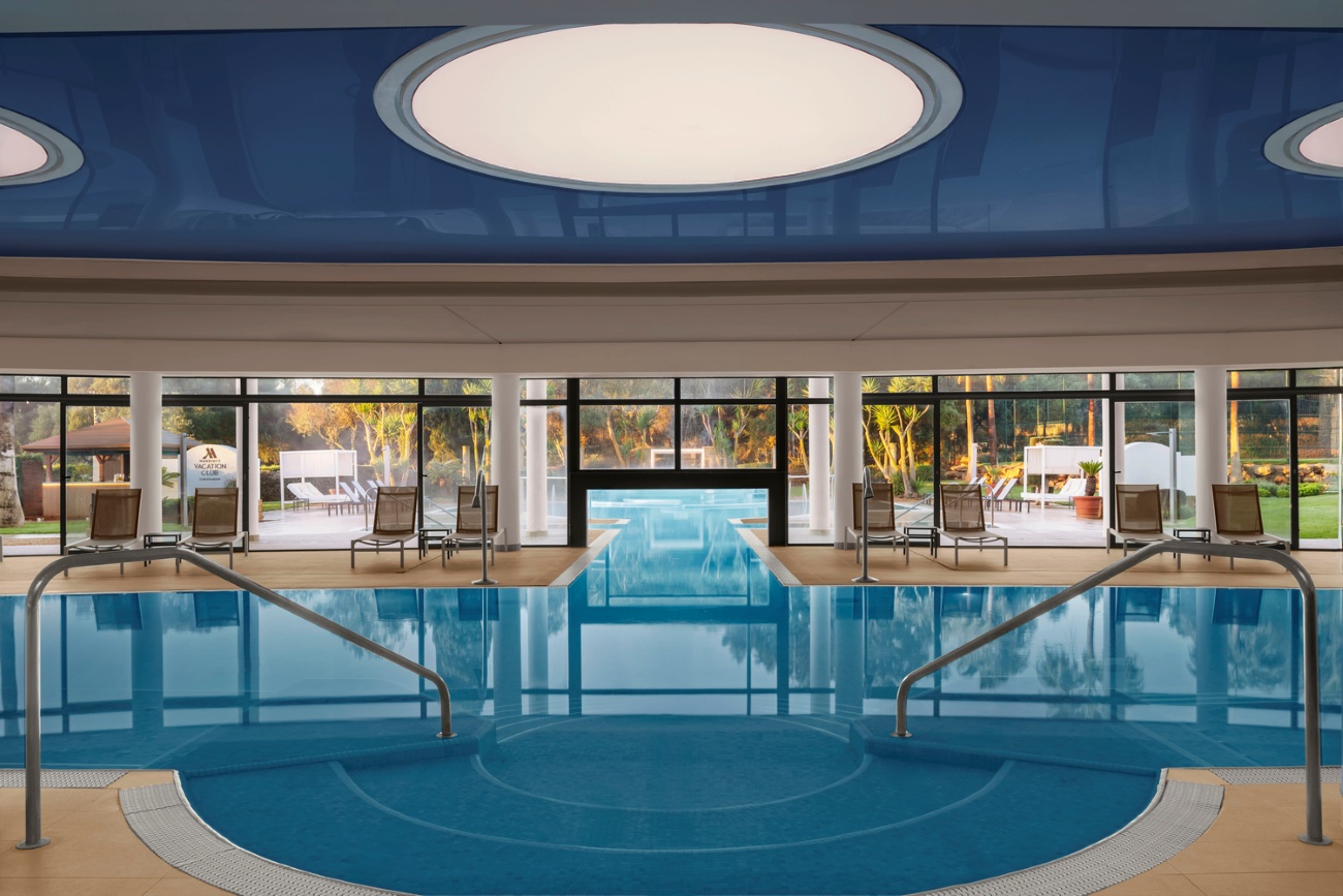 Indoor swimming pool at Son Antem resort with blue water and modern design.